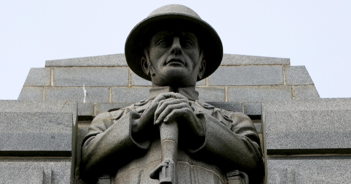 A close up of a carved granite soldier on a war memorial