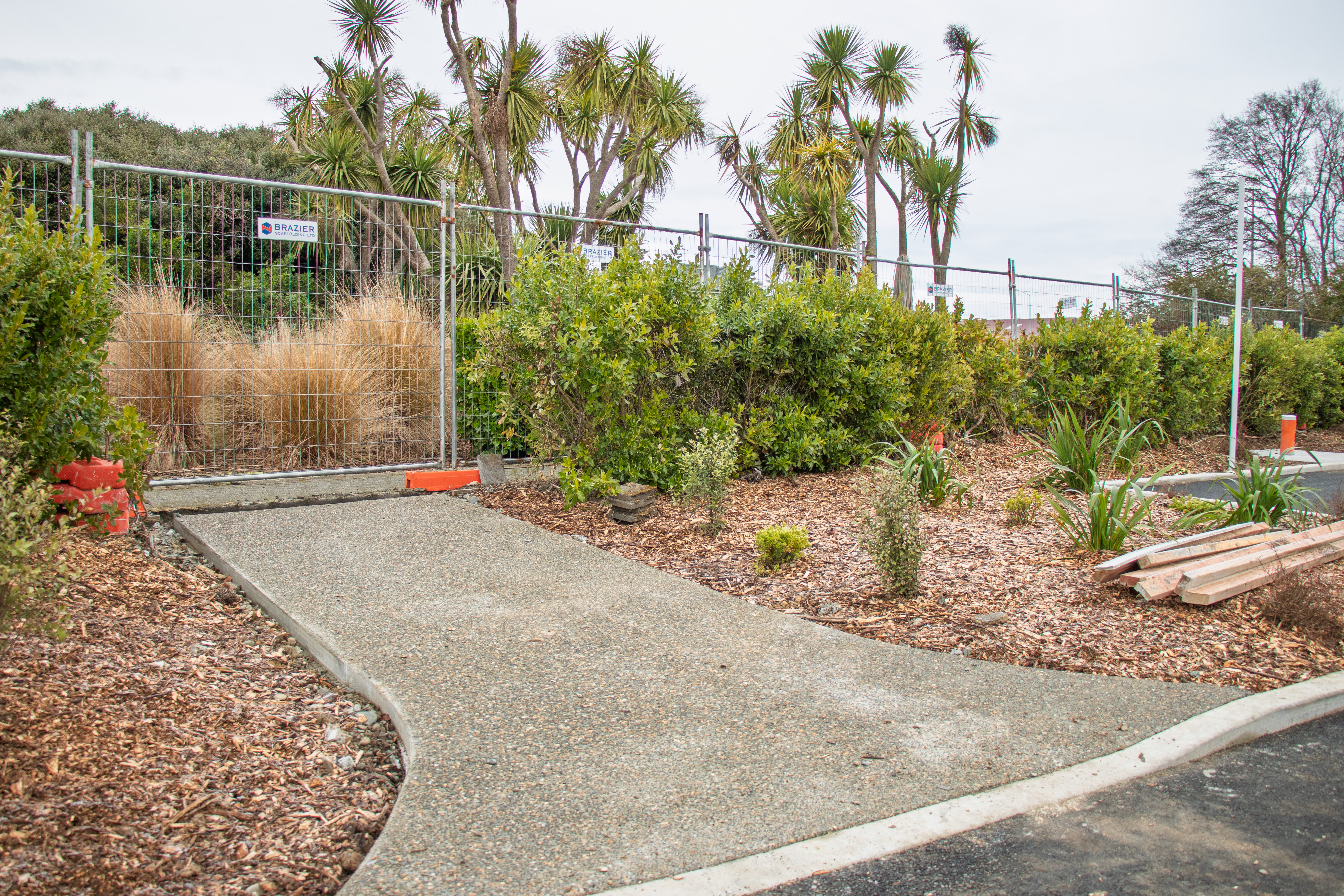 A fence on-site at Te Unua shows the new pathways and kerbing that will make the regional museum more accessible for all visitors.