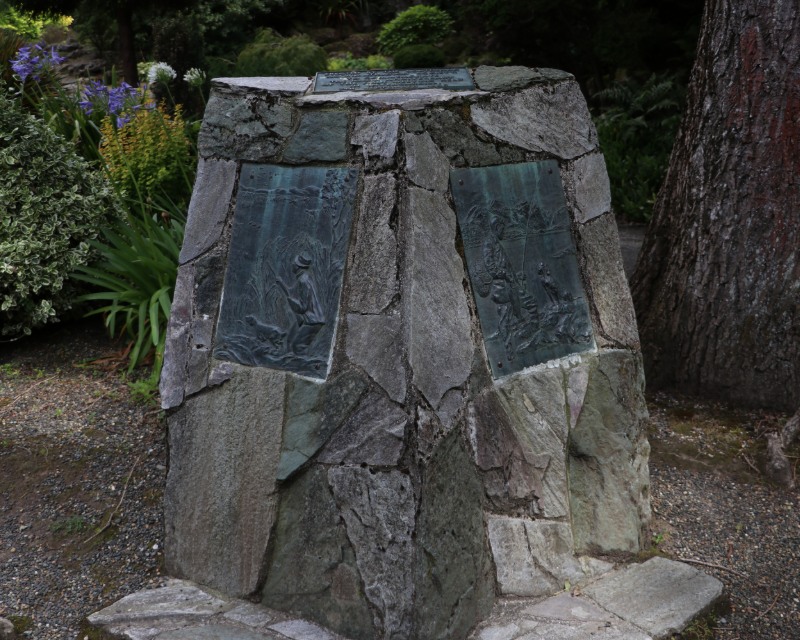 A stone plinth with brass plates.