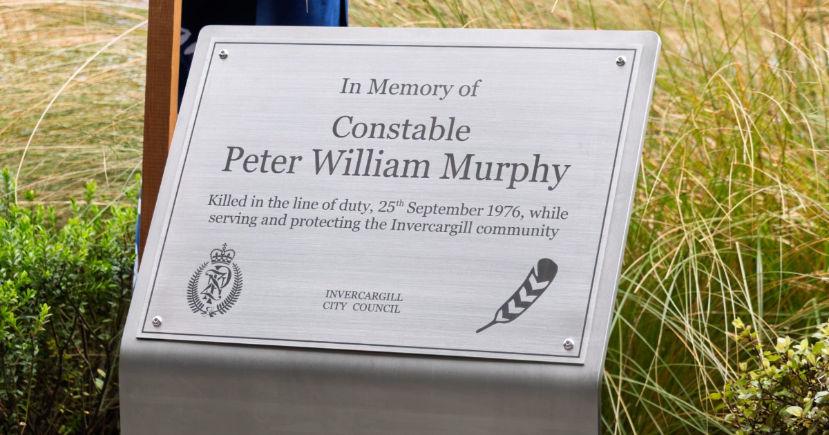 Memorial plaque honouring Constable Peter William Murphy, surrounded by plants near the corner of Dee and Esk streets.